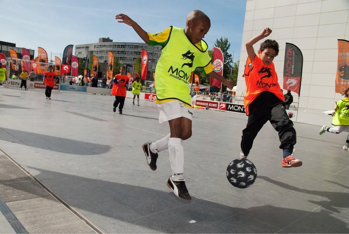 Kinderen voetballen op een plein